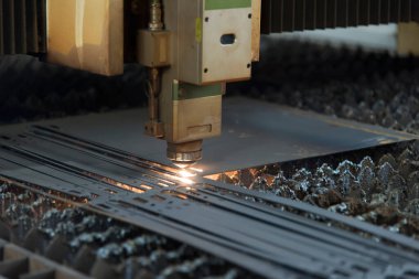 Metal levhadan kıvılcımlar kesen lazer makinesi