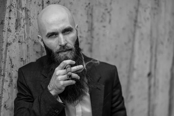 Elegant bearded man with cigar.