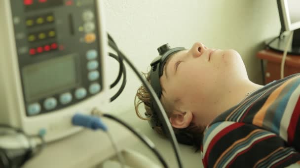 Jeune garçon obtenant un électro-encéphalogramme — Video
