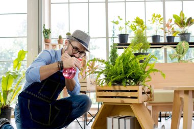Bıyıklı, yaşlı ve yakışıklı bir adam ağaç bakımıyla mutlu olur. Evde bahçıvanlık hobisi. Emeklilikten sonra mutlu yaşamak. Doğa ve çevre kavramları.