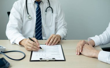 Erkek doktorlar, bir kadın hasta bir doktorla tanışıp hastalık sorunlarıyla ilgili sonuçlar aldıktan sonra tedavi öneriyor. Tıbbi ve sağlık hizmetleri kavramları.