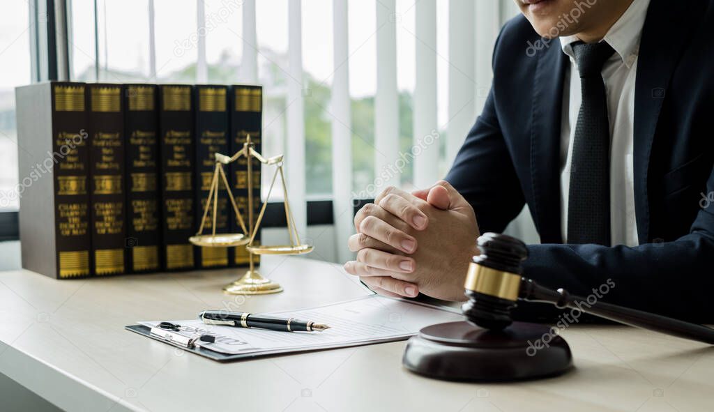 Professional man lawyers work at a law office There are scales, Scales of justice, judges gavel, and litigation documents. Concepts of law and justice.