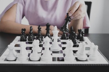 Hareket eden iş kadını eli, rekabetteki satranç liderlik, takipçiler ve ticari başarı stratejilerini gösteriyor.