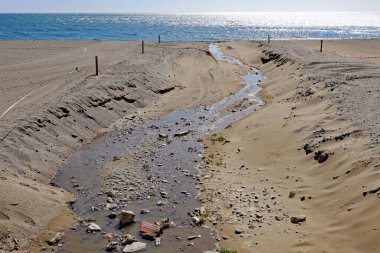 İspanya 'da Estepona sahilinde bir dere akar. İnsanların suya girmesini engellemek için bantlanmış..