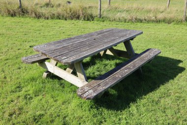 weathered picnic bench in the orchard in Dunster in Somerset, England.