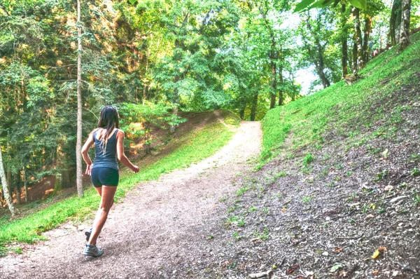 Kobieta sportowiec i biegacz działa na Park: trening jog dobrego samopoczucia. Camaldoli, Casentino, Toskania, Włochy. — Zdjęcie stockowe
