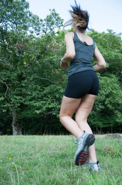 Female athlete running  on camaldoli park — Stock Photo, Image