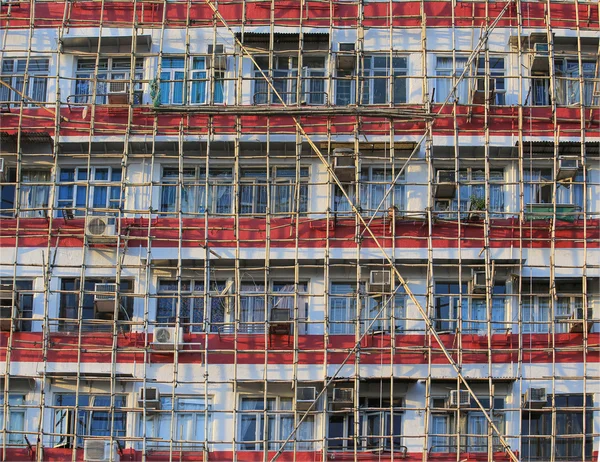 Andamios de bambú tradicional gran proyecto en frente de la oficina moderna edificio de vidrio en Hong Kong, tecnología de la vivienda asiática — Foto de Stock