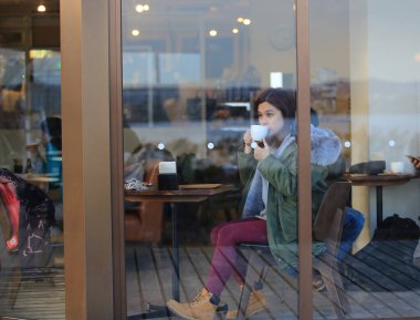 girl drink the coffee at cafe in winter