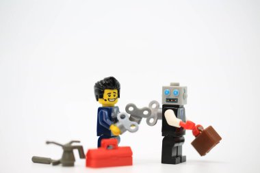 Hong Kong - July 11 2022: Man help to wind up the clockwork robot