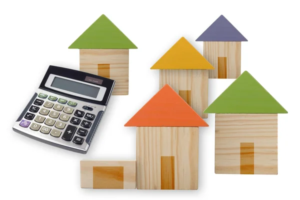 Small wooden houses and a calculator — Stock Photo, Image