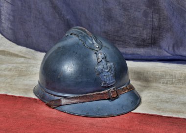 french ww 1 helmet on the antique french flag clipart