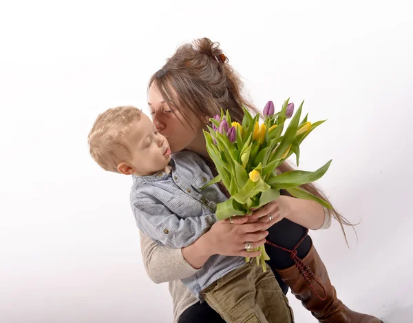 一个年轻的孩子提供鲜花给他妈妈 — 图库照片