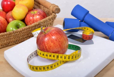 Apple placed on a scales, clipart