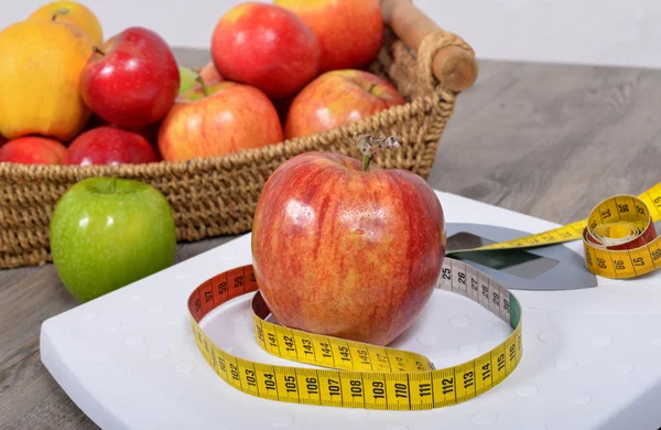 Apple placed on a scales, — Stock Photo, Image