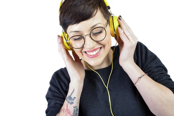 Happy young woman listening music in headphones — Stock Photo, Image