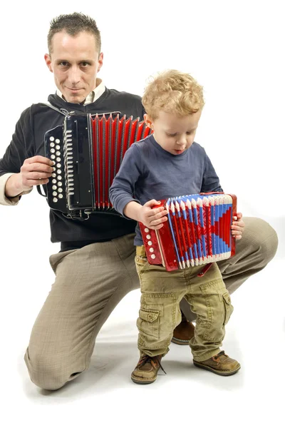 Child and young man playing the accordion — Stock Photo, Image