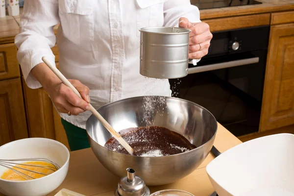 Woman hands melted chocolate mixture with flour — Stock Photo, Image