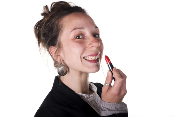 Young business woman is putting on lipstick — Stock Photo, Image