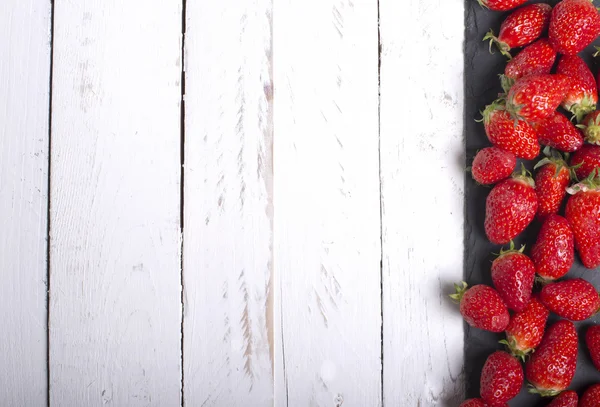 Strawberries on a white tabletop eve — Stock Photo, Image