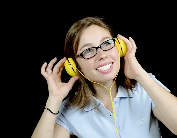 Mujer joven escuchando música con un auricular —  Fotos de Stock