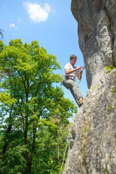 Giovane donna arrampicata su una parete di roccia — Foto Stock