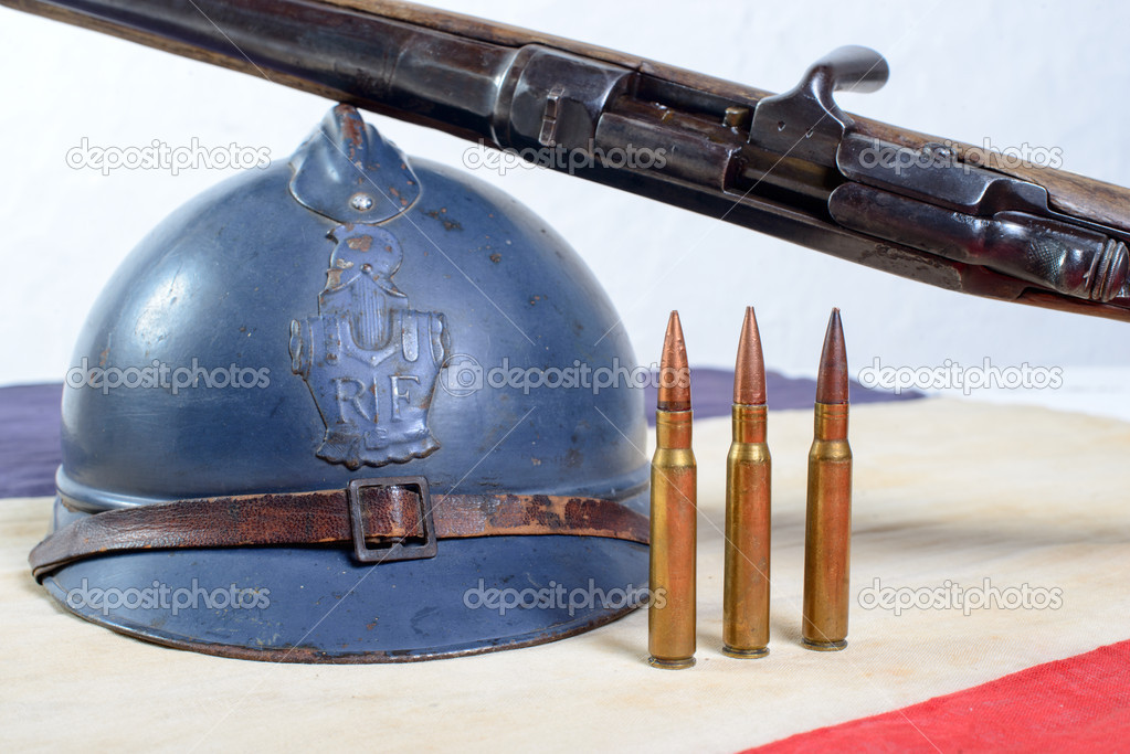 french helmet of the First World War with a gun on a red white b
