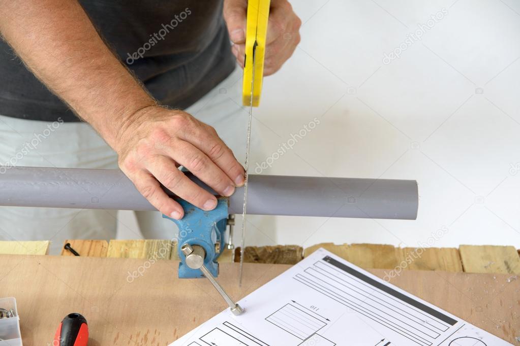 A plumber cut PVC pipe