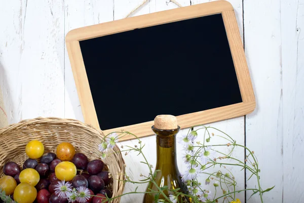 Blackboard with yellow and red plum — Stock Photo, Image