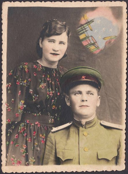 Family portrait of a junior lieutenant of the Armed Forces of the USSR with his wife. Retouched old photo, circa 1950s