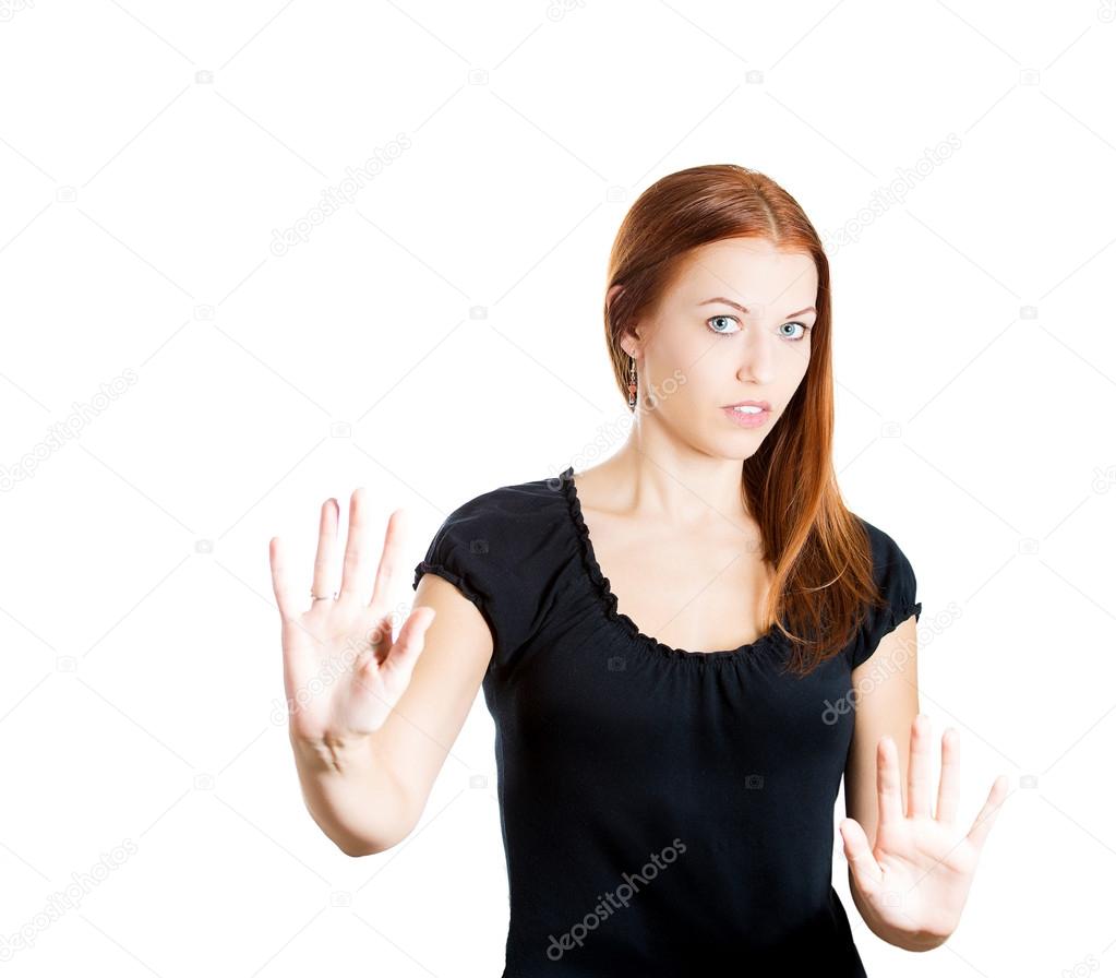 Closeup portrait of beautiful woman raising hands up to say no, stop right there