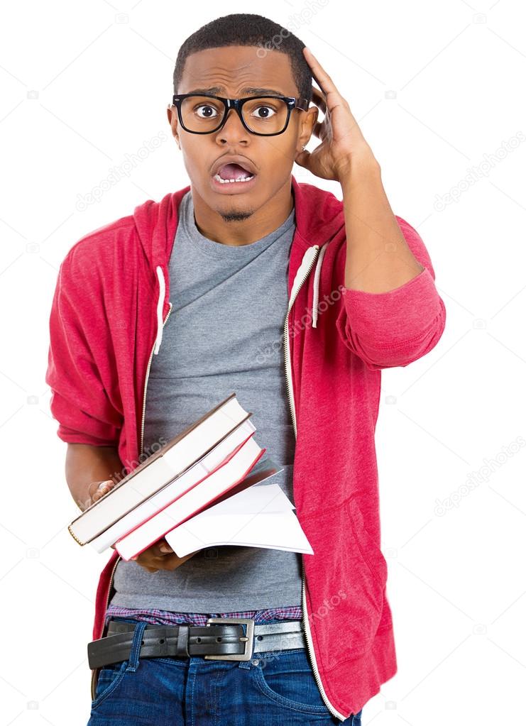 Closeup of a young handsome man, wearing big glasses, holding books, anxious in anticipation of finals, exam test