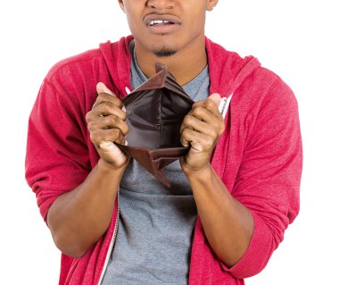 Closeup portrait of stressed, upset, sad, unhappy young man standing with, looking into empty wallet clipart
