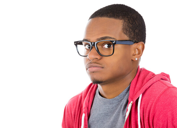 Closeup portrait of a young nerdy looking man with glasses, very timid, suspicious shy and anxious looking at camera