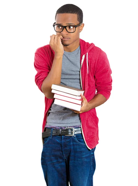 Closeup of a young handsome man, wearing big glasses, holding books, anxious in anticipation of finals, exam test Stock Image
