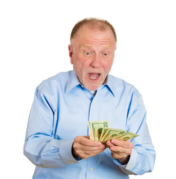 Zralý muž drží peníze dolarové bankovky v ruce — Stock fotografie