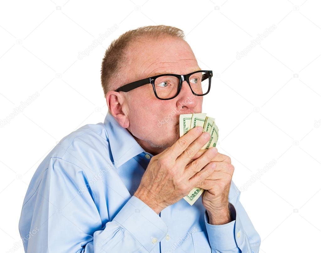 Mature man kissing dollar banknotes