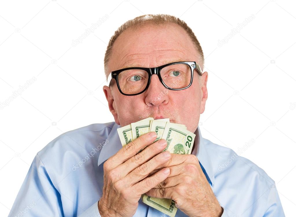 Mature man kissing dollar banknotes