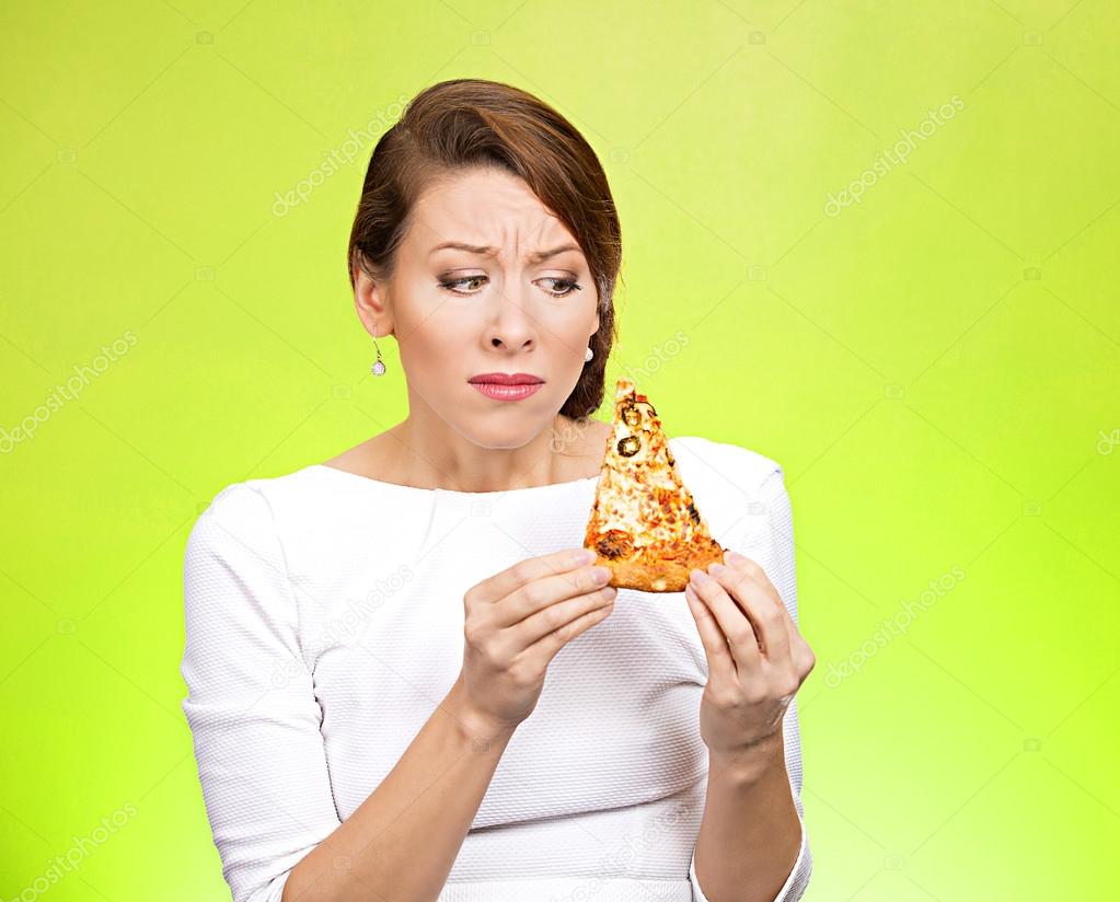Young woman holding fatty pizza