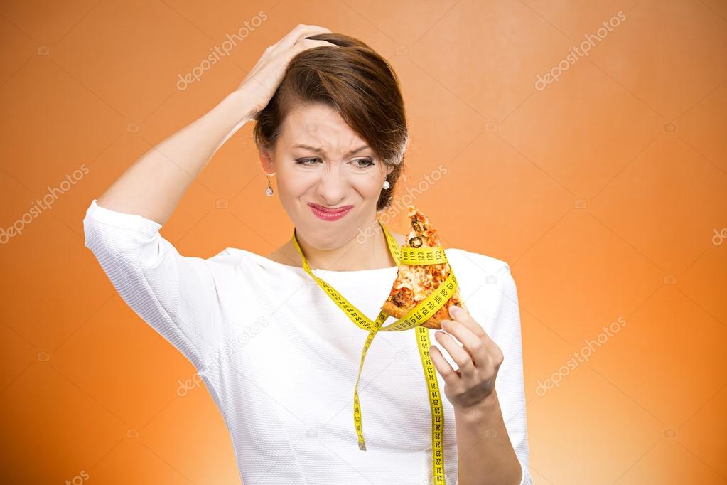 Woman holding pizza with measuring tape around