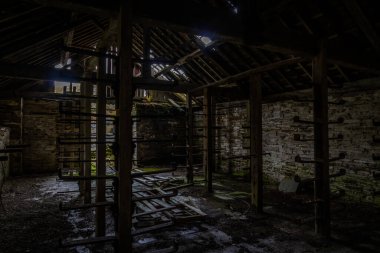 Old store room in abandoned slate quarry with metal racks, disused slate quarry, landscape.