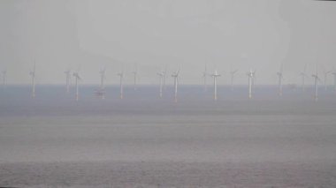 Video, Rows of Wind turbines at sea from Llandudno, North Wales, UK.    