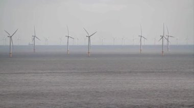 Video, large farm  of Wind turbines at sea from Llandudno, North Wales, UK.    