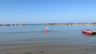 Adriyatik Rivierası. Denizde yürüyen yaşlı kadın. 