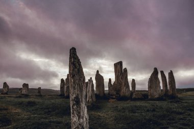 Selective focus on front stone. Ancient magic in the Calanais Standing Stones Circle, erected by neolithic men for worship. Celtic traditions in the outer hebrides of Scotland. Touristic attraction.