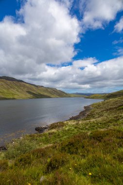 Scottish Highlands typical landscaped and scenery, bright green lawns, roads to nowhere, tranquil lochs. Fairy tale views.