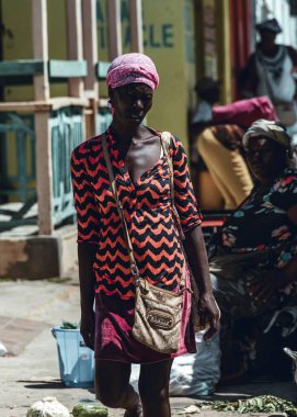 Pedernales, Dominican Republic, 22 august 2022. Touring in the Haitan Market near the border with Haiti, with goods, foods and ladies browsing, selling and buying. Intense haitian woman portrait.