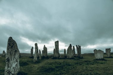 Ancient magic in the Calanais Standing Stones Circle, erected by neolithic men for worship. Celtic traditions in the outer hebrides of Scotland. Touristic attraction. clipart