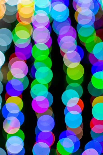 Colored blurred lights, defocused background. New Year Christmas background with multicolored blurred lights. — Stock Photo, Image