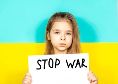 Bir kız ağlıyor, elinde Ukrayna bayrağının arka planına karşı bir DUR Savaş posterini tutuyor. Ukrayna 'daki savaşı durdurun. Ukrayna 'da barış kavramı. Yazı metni için yer